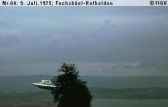 #64.[31] Semjase flying with her beamship around a wettertanne (weather pine) 14m height (the tree later eliminated by Semjase). Pfaffikersee in background. 9th July 1975.